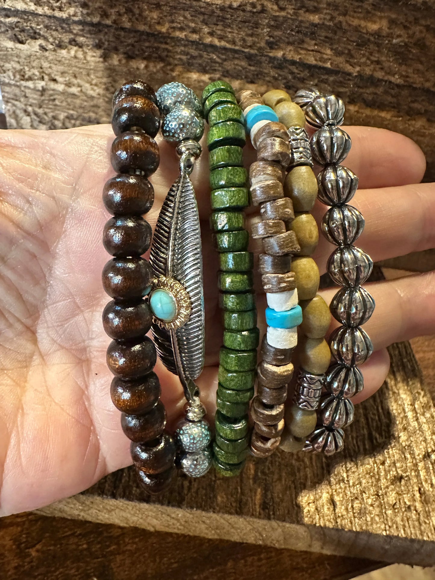 Shop Bohemian Hippie Bracelet Set: 4-piece chic wooden beads & love feather stretch bracelets in a gift box. Stylish, meaningful, and perfect for layering. Buy now!