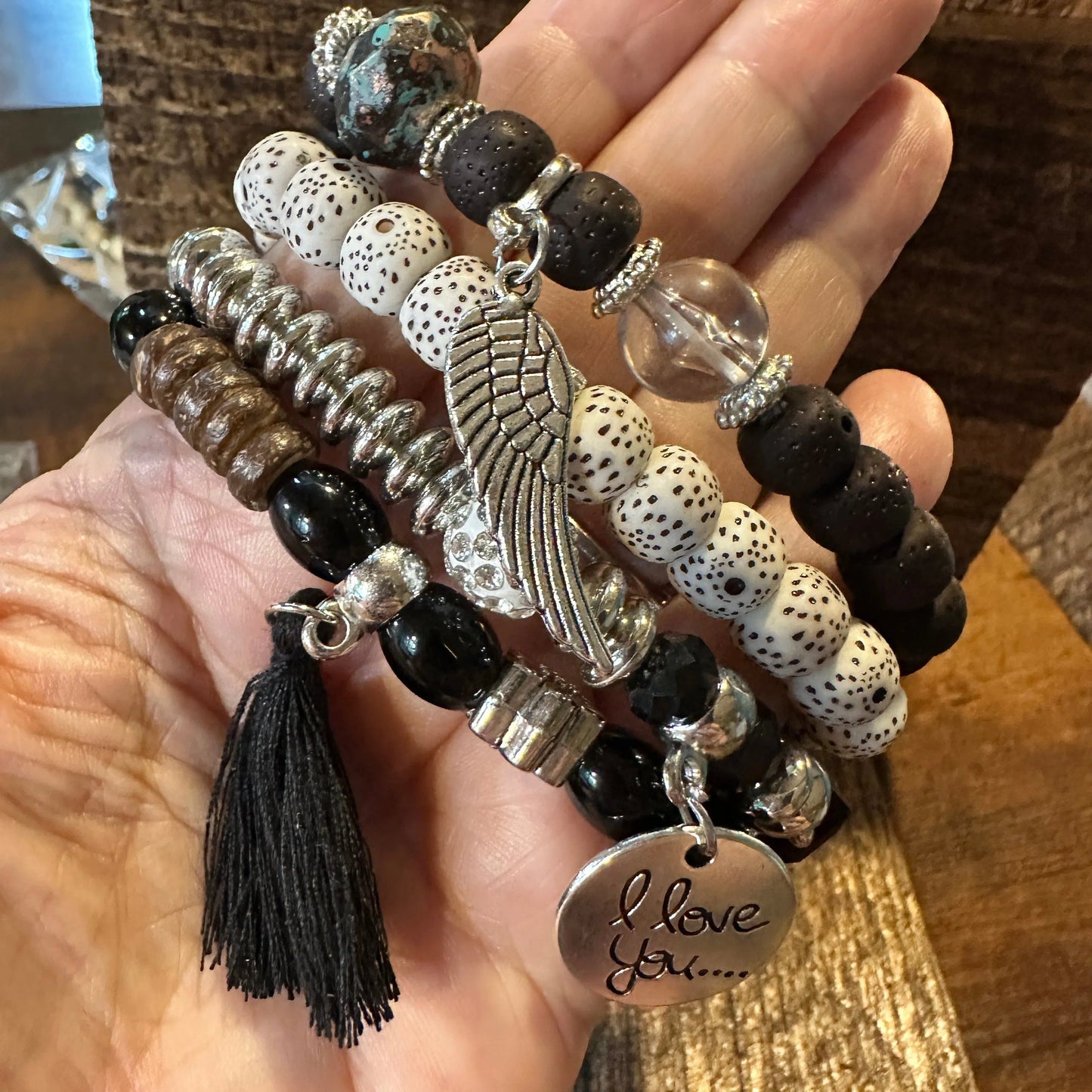 Bohemian Hippie Bracelet Set featuring chic brown wooden beads, love feather charms, and a stretch cord design. 4-piece set in a gift box. - Silver Elegant