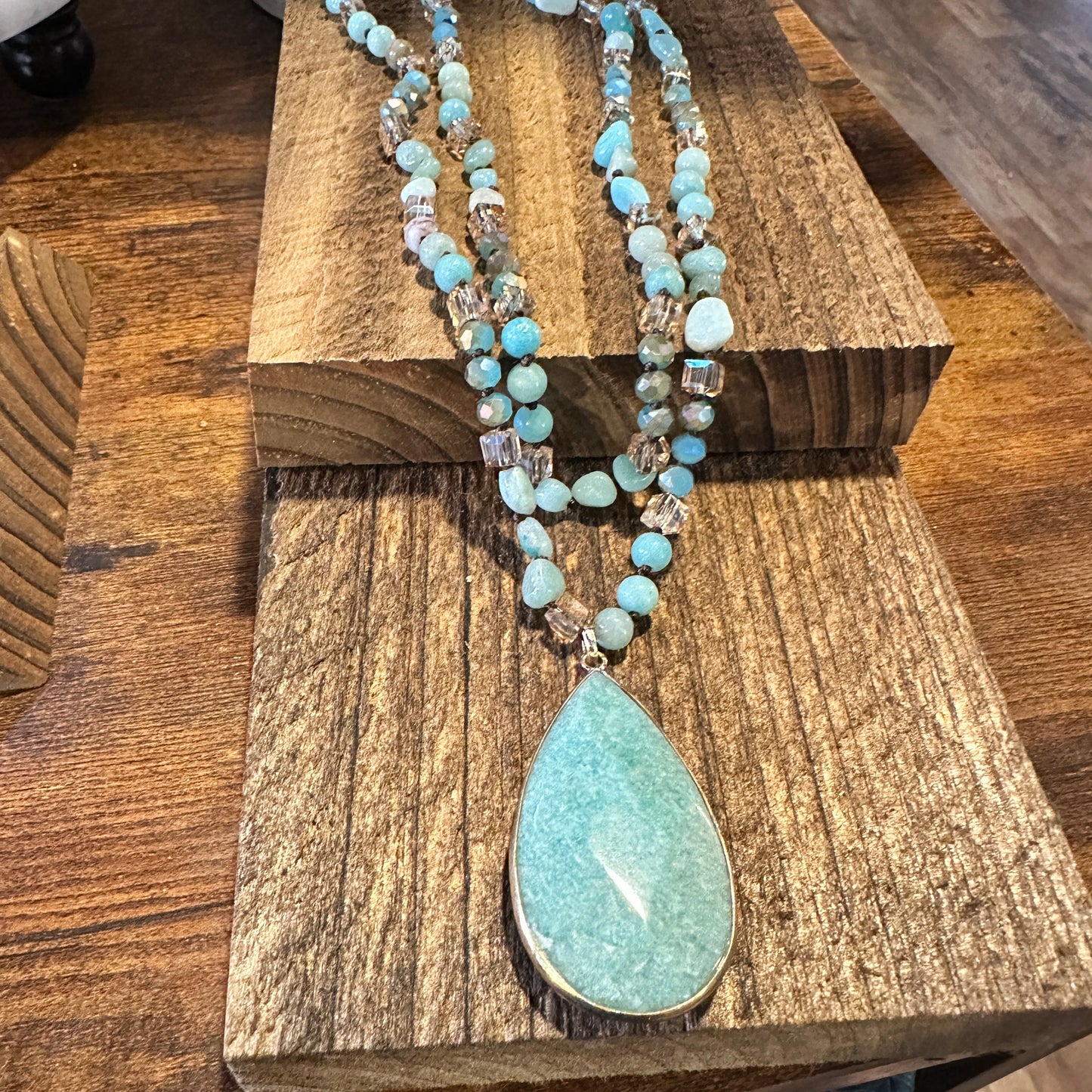 The handcrafted Bohemian Natural Green Pendant Necklace features a vibrant green pendant and rock crystal quartz beads, and it is elegantly gift-boxed. - Silver Elegant