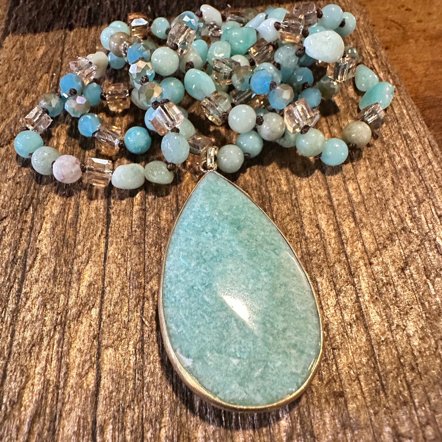 The handcrafted Bohemian Natural Green Pendant Necklace features a vibrant green pendant and rock crystal quartz beads, and it is elegantly gift-boxed. - Silver Elegant