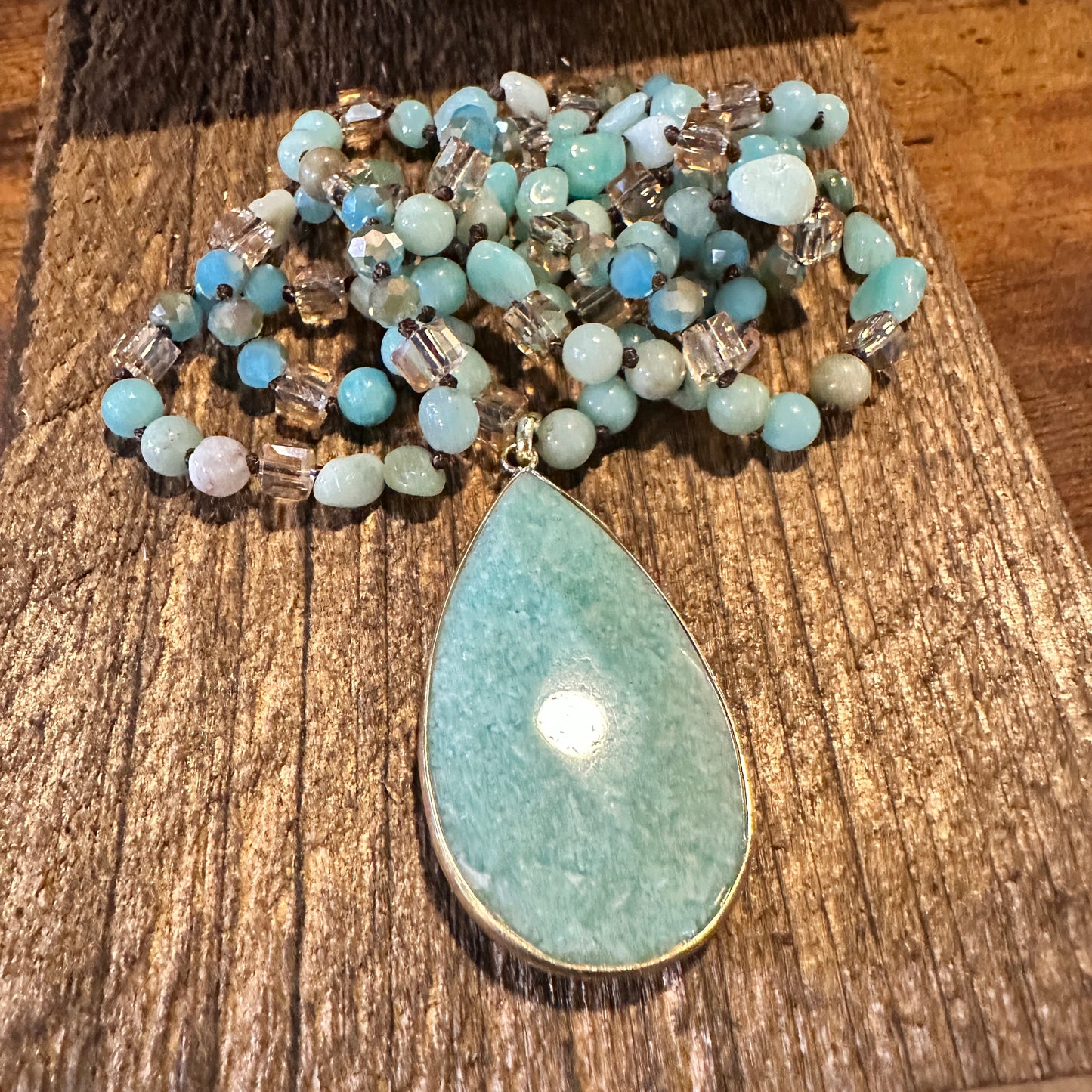 The handcrafted Bohemian Natural Green Pendant Necklace features a vibrant green pendant and rock crystal quartz beads, and it is elegantly gift-boxed. - Silver Elegant