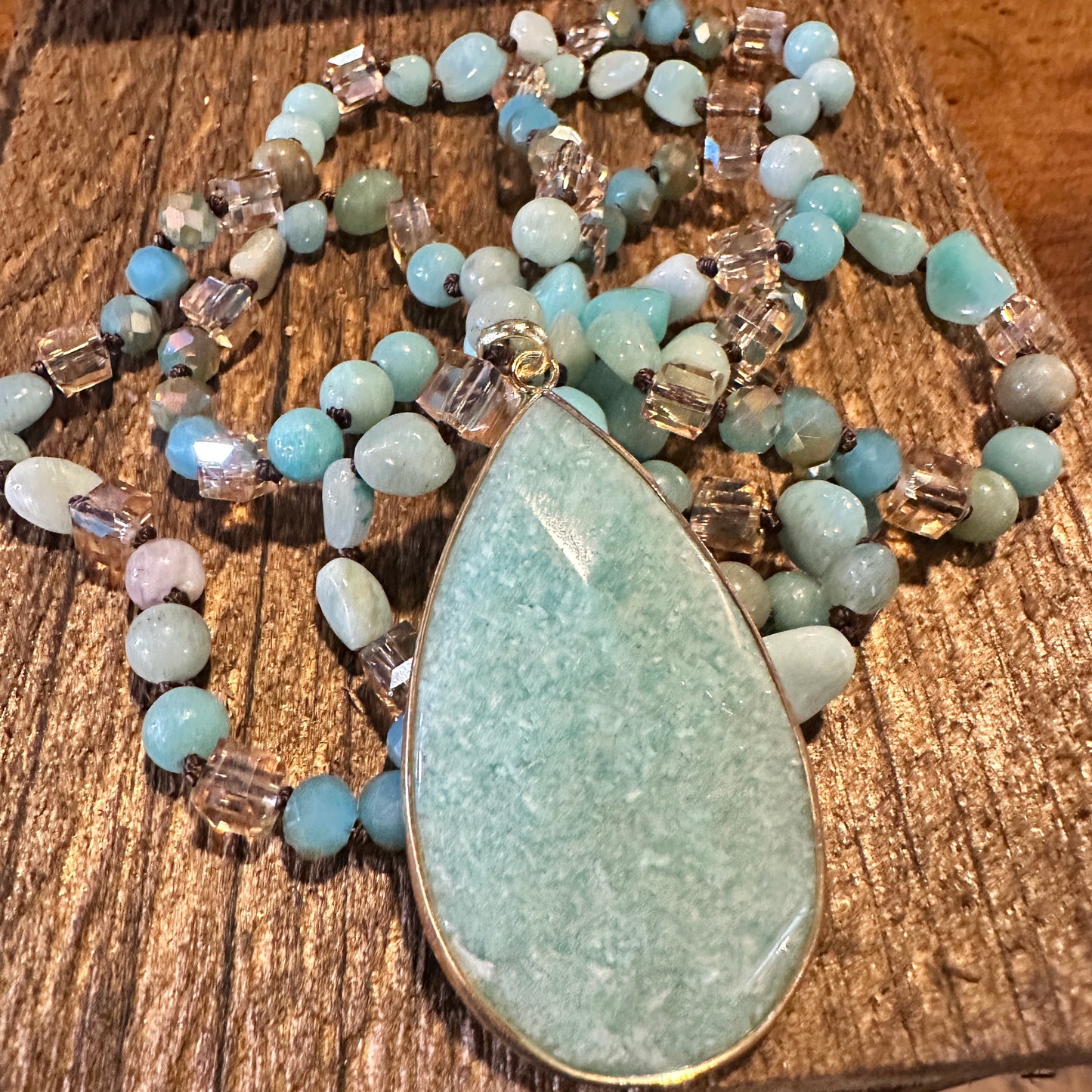 The handcrafted Bohemian Natural Green Pendant Necklace features a vibrant green pendant and rock crystal quartz beads, and it is elegantly gift-boxed. - Silver Elegant