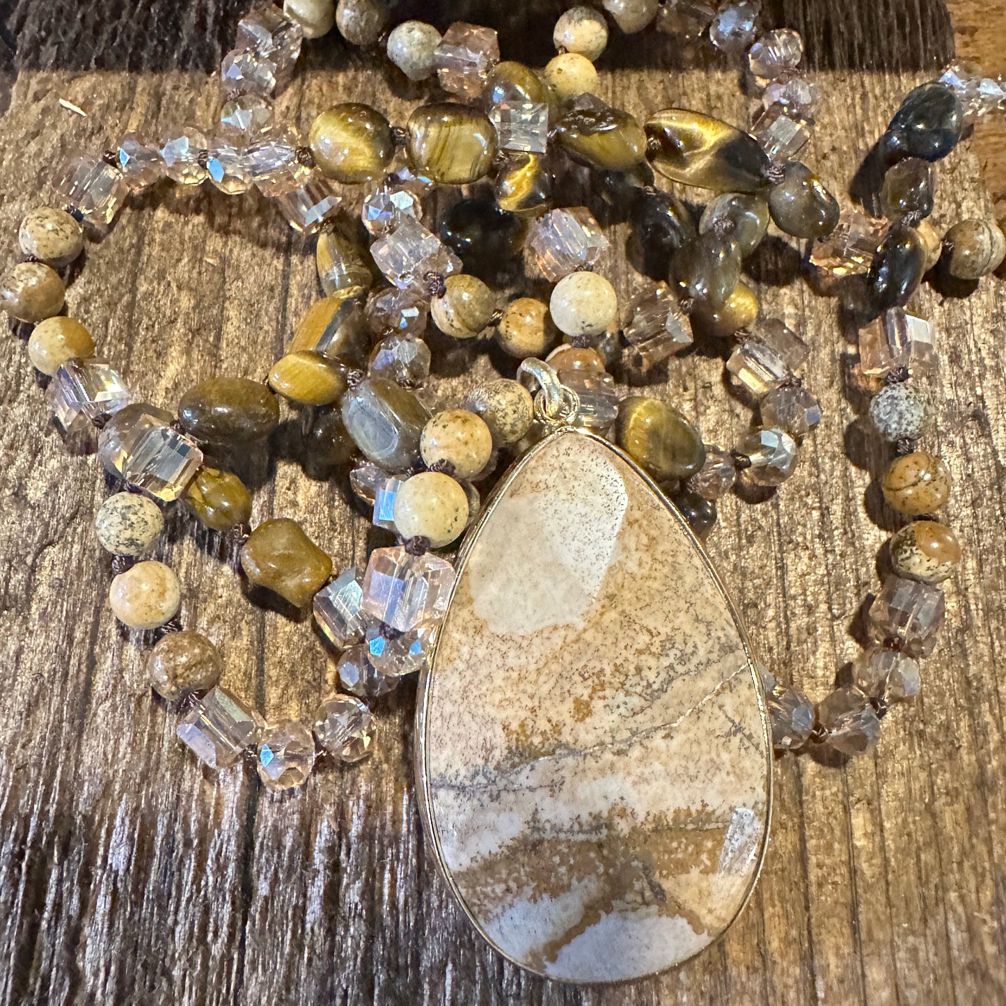 Bohemian Natural Stone Glass Knot Pendant Necklace featuring a brown natural stone pendant with a delicate glass knot design. Ships in an elegant gift box.- Silver Elegant