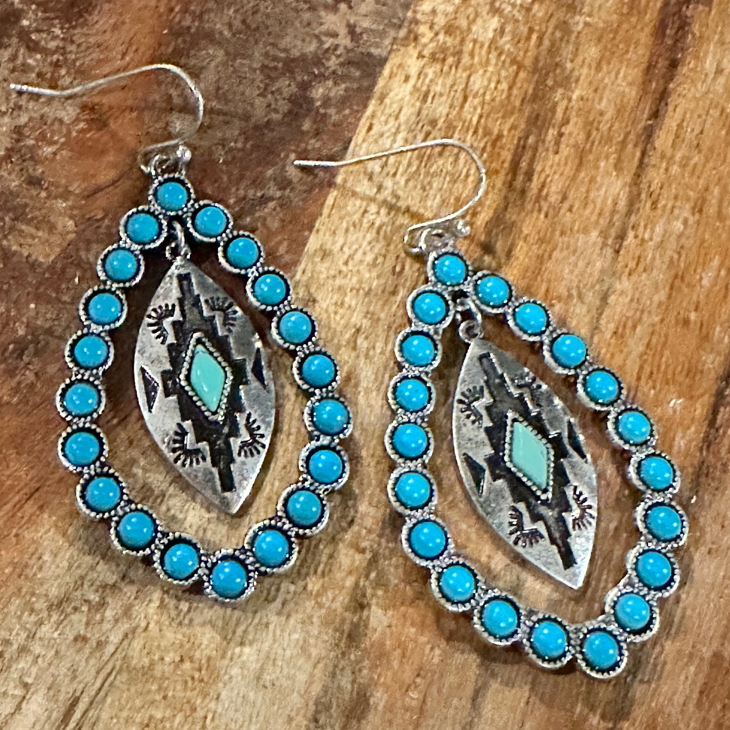 Aztec-inspired Teardrop Turquoise Earrings featuring a vibrant turquoise coating and intricate patterns, perfect for a bold, chic statement.