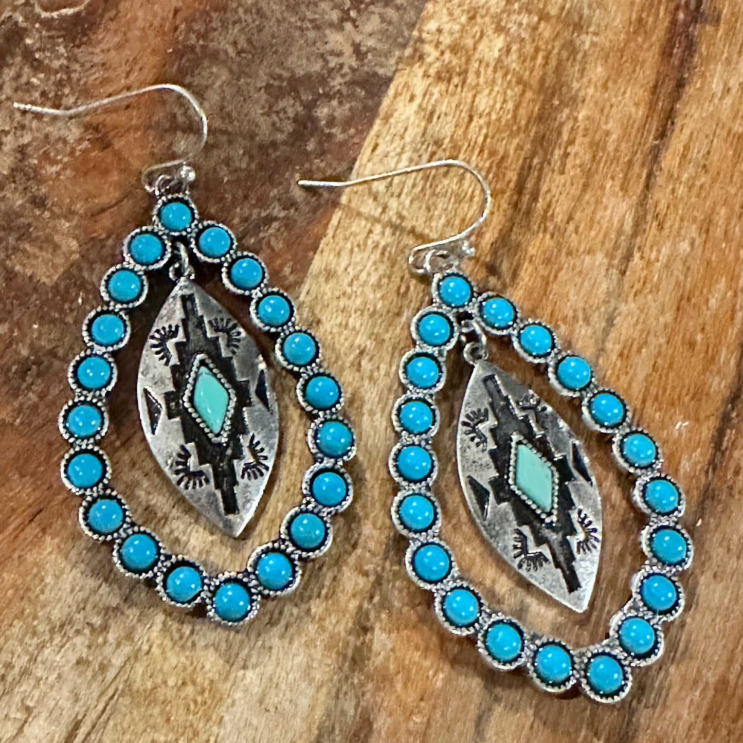 Aztec-inspired Teardrop Turquoise Earrings featuring a vibrant turquoise coating and intricate patterns, perfect for a bold, chic statement.
