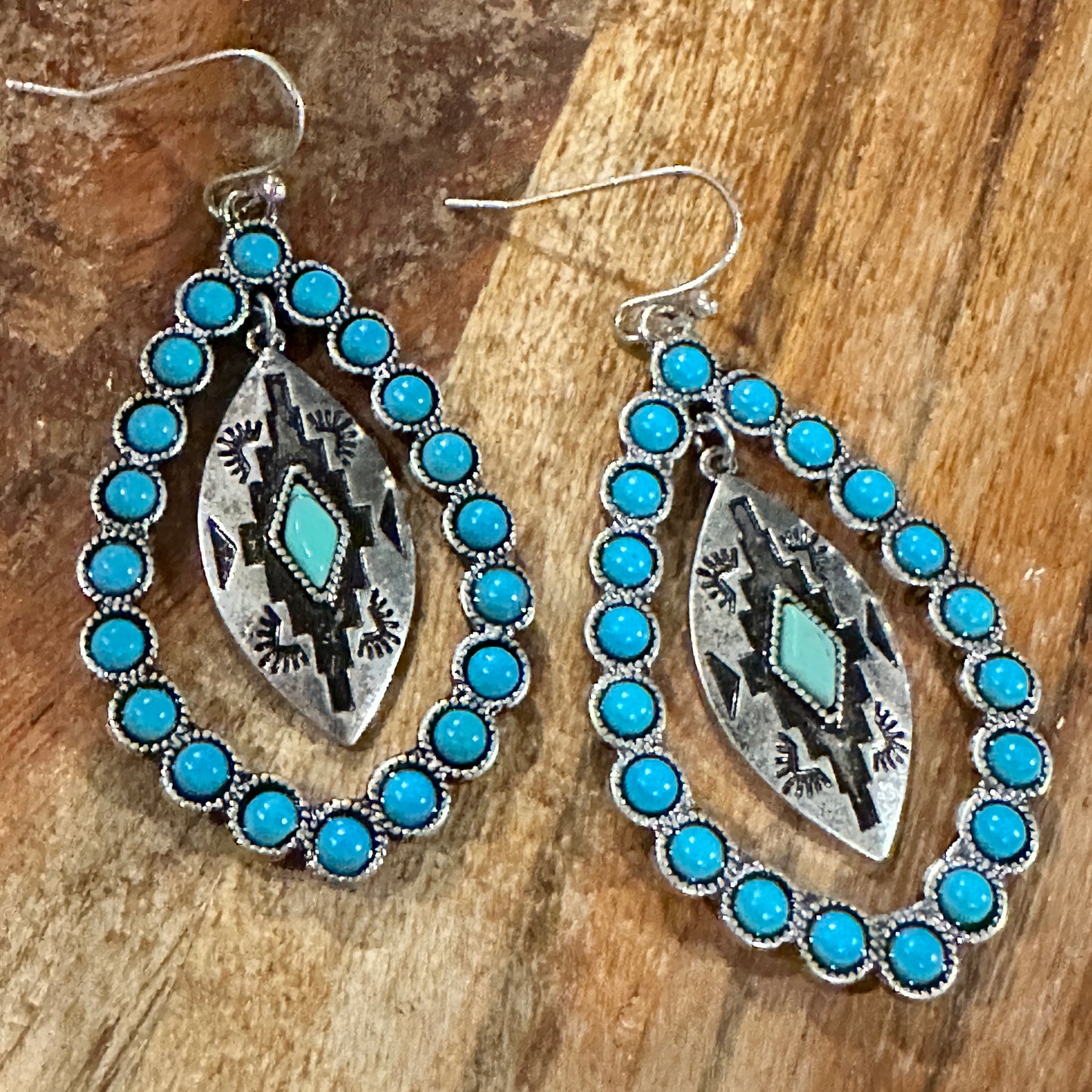 Aztec-inspired Teardrop Turquoise Earrings featuring a vibrant turquoise coating and intricate patterns, perfect for a bold, chic statement.