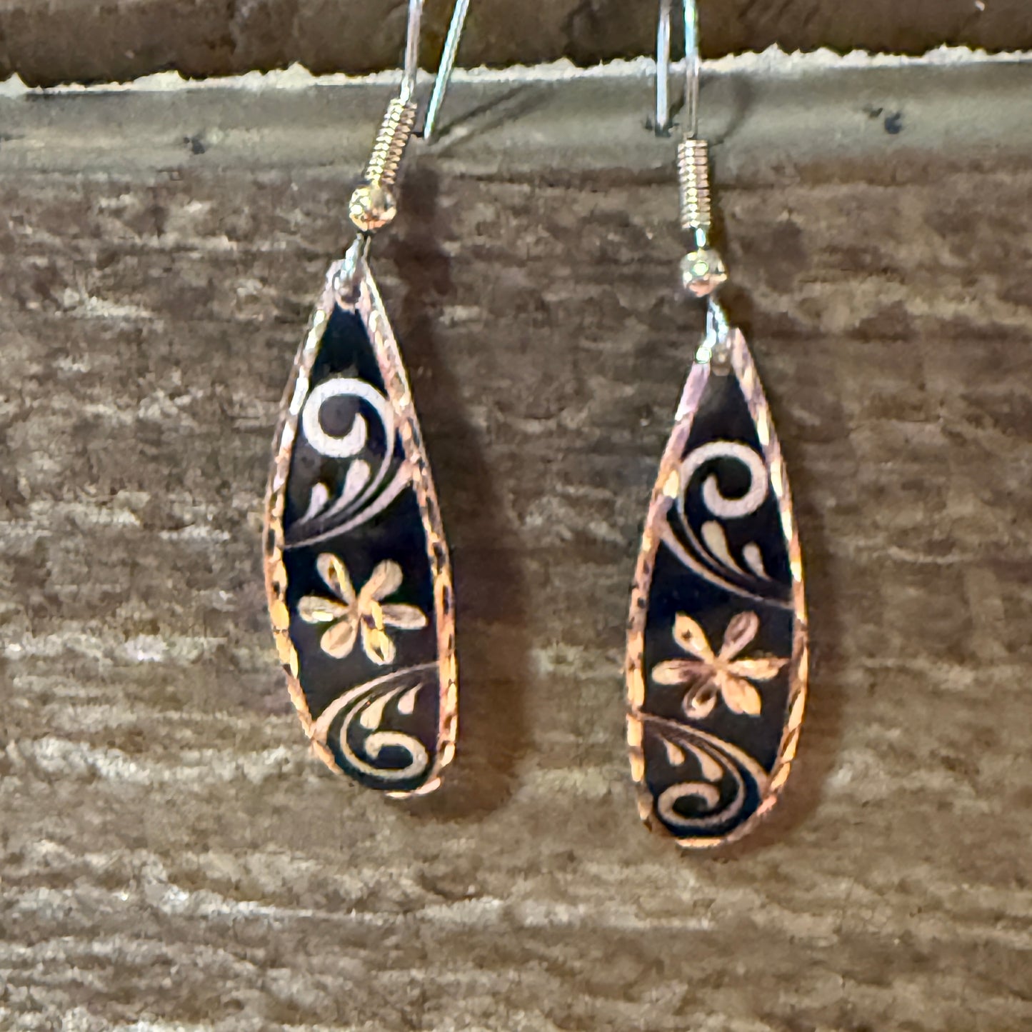 Handcrafted copper rose-gold floral wire drop earrings with black enamel and gold flower scrolls