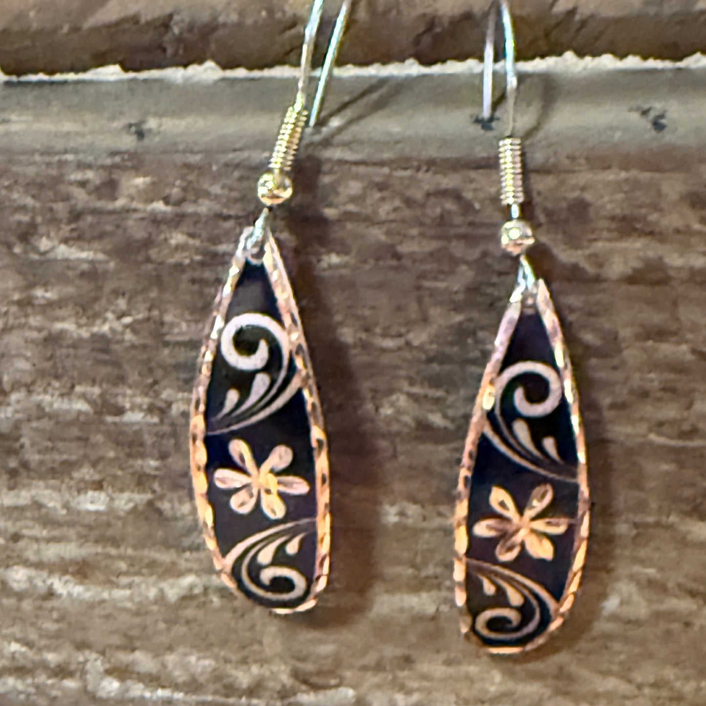 Handcrafted copper rose-gold floral wire drop earrings with black enamel and delicate scrollwork.