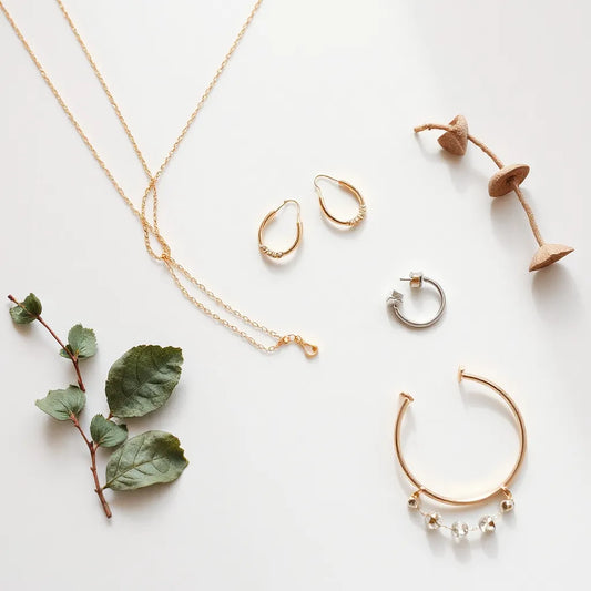 Gold and silver necklaces and earrings arranged neatly on a light background with soft natural lighting