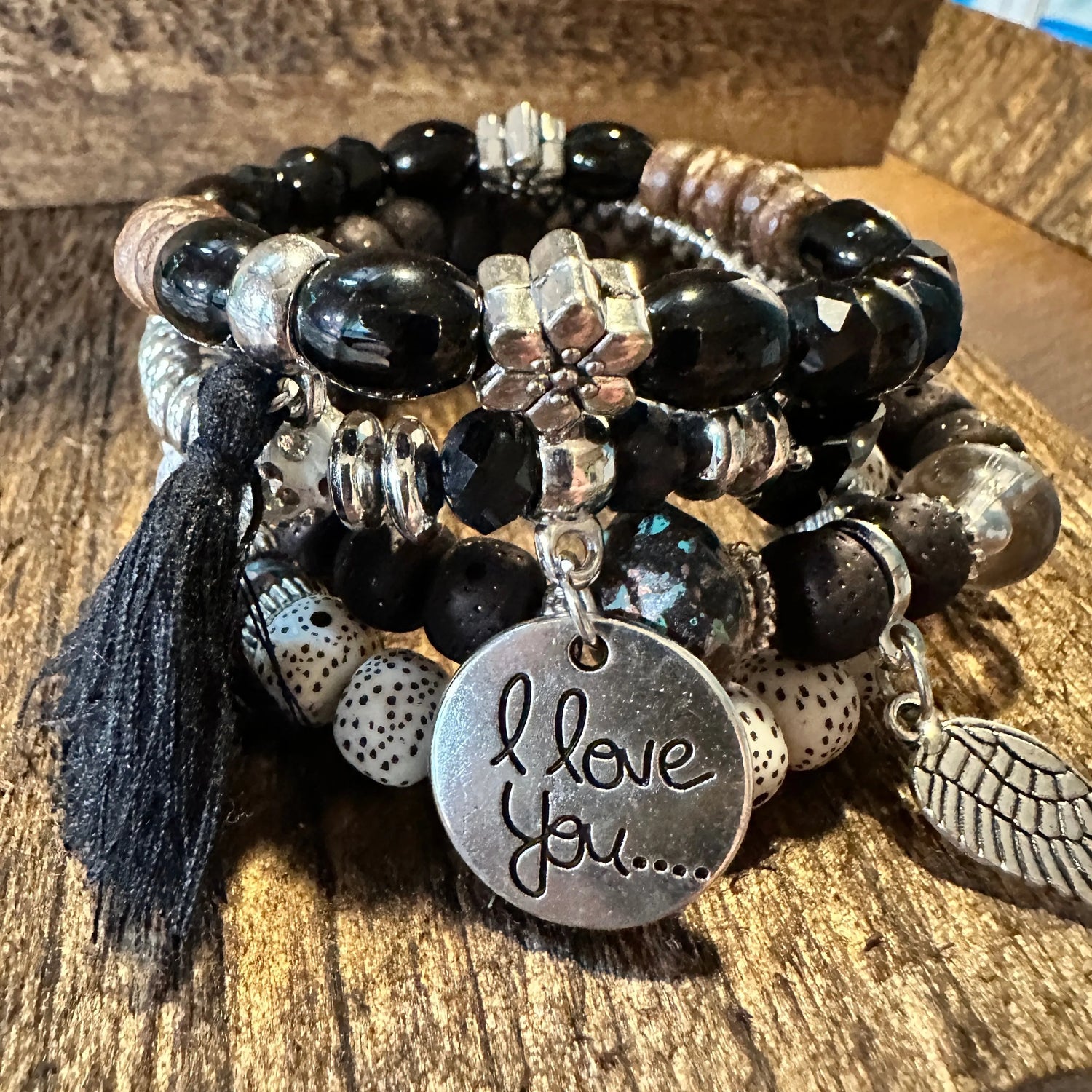 Bohemian Hippie Bracelet Set featuring chic brown wooden beads, love feather charms, and a stretch cord design. 4-piece set in a gift box.