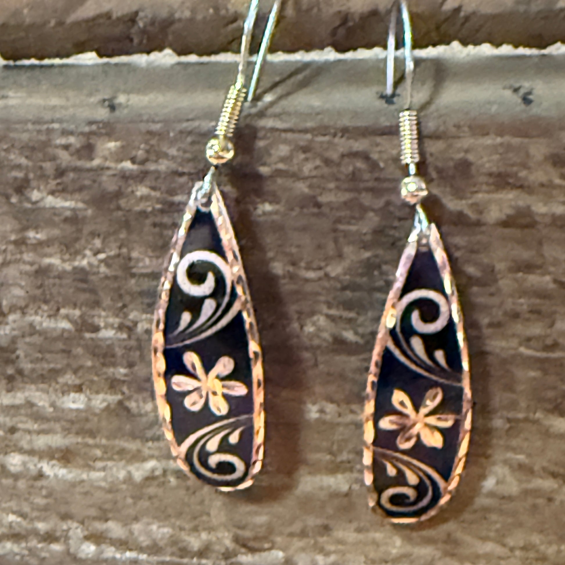 Handcrafted copper rose-gold floral wire drop earrings with black enamel and delicate scrollwork.