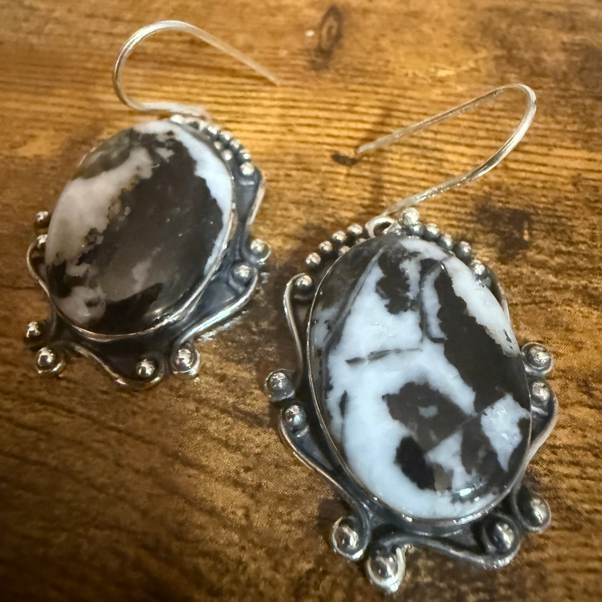 White Buffalo Turquoise Dahlia Sterling Silver drop earrings with oval marbled stones and beaded frames.