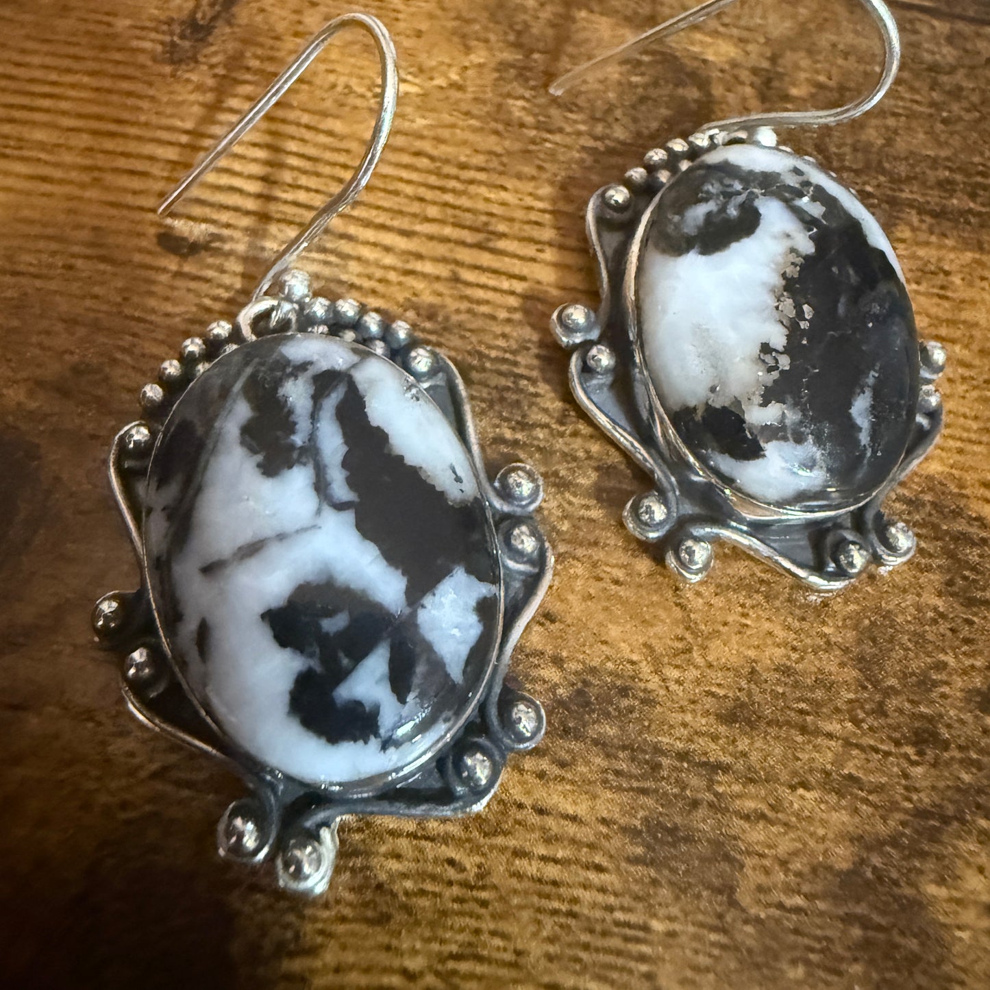 White Buffalo turquoise oval cabochon earrings in sterling silver drop with beaded border.
