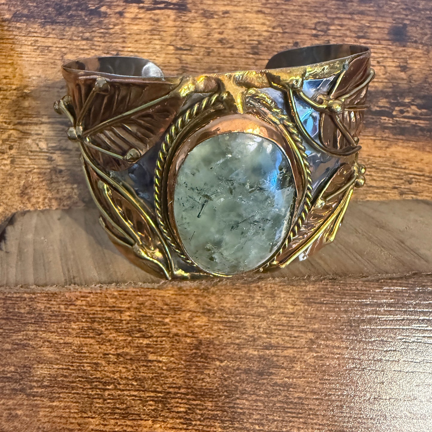 Moss agate natural stone wide cuff bracelet in mixed metals with leaf details.