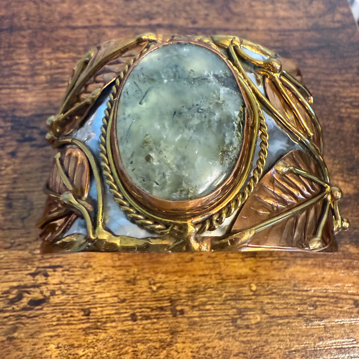 Moss agate natural stone wide cuff bracelet with mixed metals and leaf motifs.